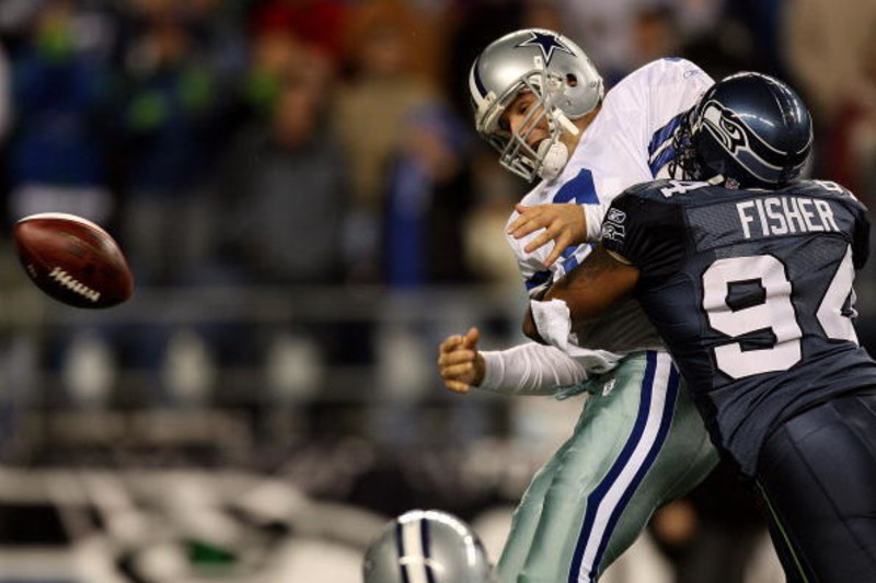 Dallas Cowboys quarterback Tony Romo (9) puts his hand to his face