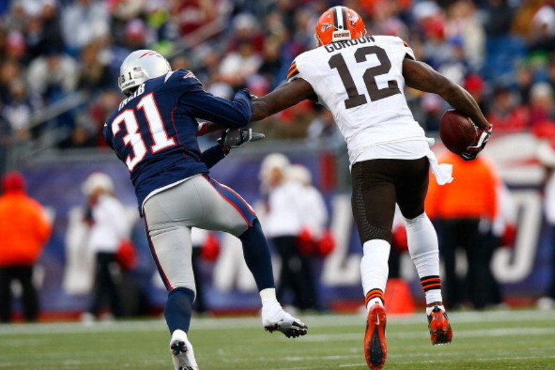 New England Patriots quarterback Tom Brady (12) sails after being hit by Denver  Broncos cornerback Aqib Talib on a first down run in the second quarter  during the AFC Championship game at