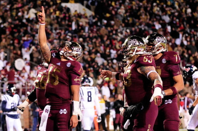 Dak Prescott Mississippi State Bulldogs Unsigned Maroon Jersey Touchdown Celebration During Liberty Bowl Photograph