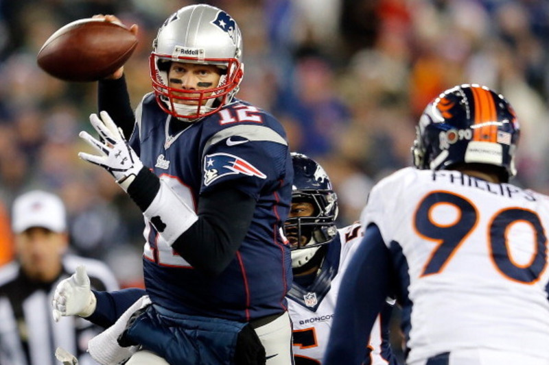 Tom Brady (12) of the New England Patriots throws a pass during the AFC  Championship game at Sports Authority Field at Mile High in Denver on  January 19, 2014. The New England-Denver