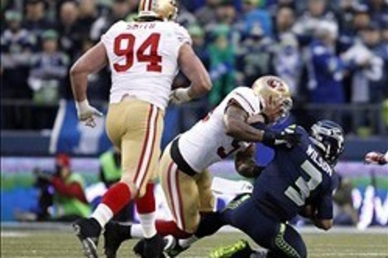 Seattle Seahawks quarterback Russell Wilson (3) gets sacked by Washington  Redskins cornerback Josh Wilson (26) in the third quarter of an NFC  wild-card playoff game at FedEx Field in Landover, Maryland, Sunday