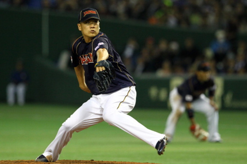 Japanese baseball pitcher Masahiro Tanaka wearing his jersey poses