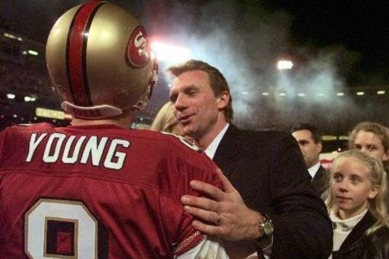 San Francisco 49er quarterback Steve Young talks with fellow