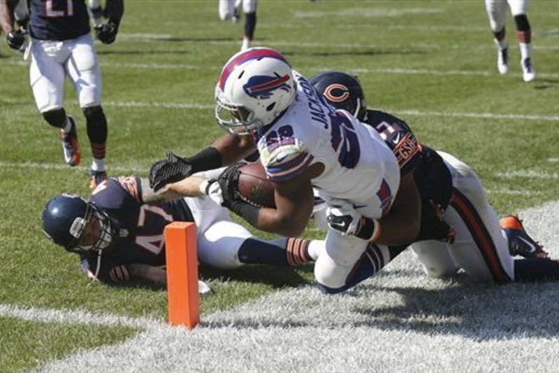 San Francisco 49ers Frank Gore (centre) breaks through the Denver