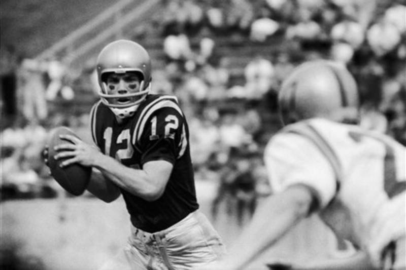 Dallas Cowboys quarterback Roger Staubach (12) looks for a receiver during  the NFC Championship game against the Washington Redskins at RFK Stadium in  Washington, DC on December 31, 1972. Blocking for Staubach