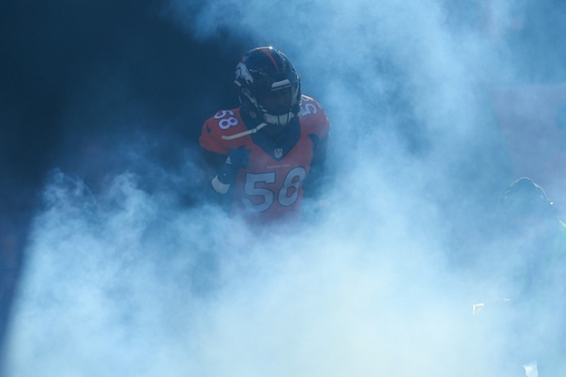 Players take the field running through smoke before the Raiders