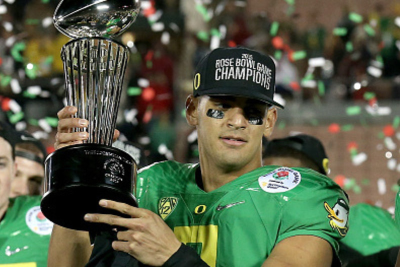 Oregon Ducks quarterback Marcus Mariota (8) warms up before the game  against the Florida State Seminoles at the College Football Playoff  Semifinal of the Rose Bowl in Pasadena, California on January 1