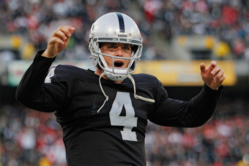 Oakland Raiders quarterback Derek Carr (4) and head coach Jack Del Rio  watch a replay during the second half of an NFL football game against the  San Diego Chargers in Oakland, Calif.