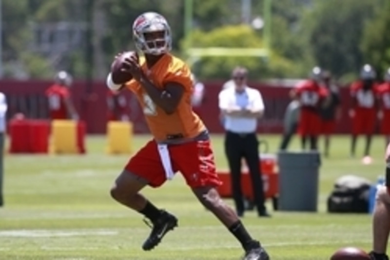 TAMPA, FL - MAY 13: Tampa Bay Buccaneers Logan Hall (90) talks with a team  official before the Tampa Bay Buccaneers Rookie Minicamp on May 13, 2022 at  the AdventHealth Training Center