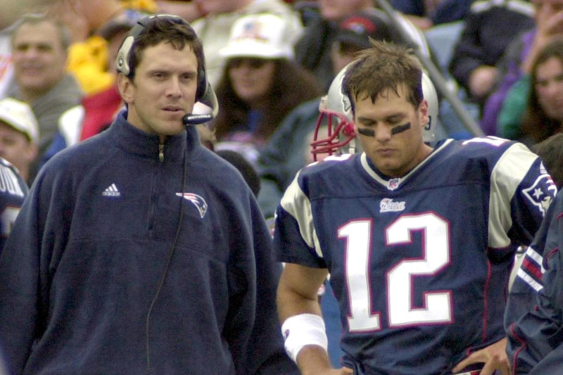 Members of the New England Patriots 2001 Super Bowl XXXVI team Lawyer Milloy,  left, and Drew Bledsoe, right, high five while standing on stage near  Patriots owner Robert Kraft, center, as they