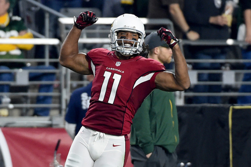 Larry Fitzgerald of the Phoenix Cardinals smiles holding the game