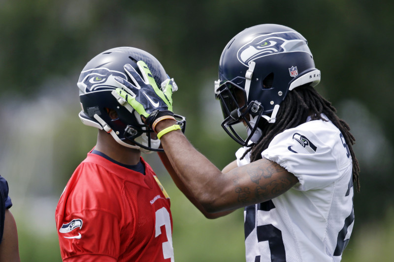 Seattle Seahawks head coach Pete Carroll reacts to a holding card