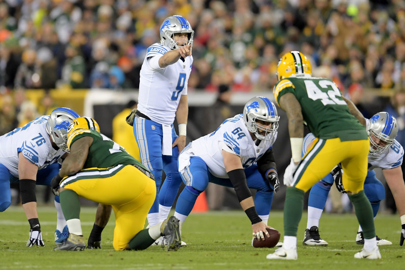 Bulldogs In The NFL - Image 1: Green Bay Packers quarterback Aaron Rodgers  (12) holds the football out while trying to gain a first down as Chicago  Bears inside linebacker Danny Trevathan (