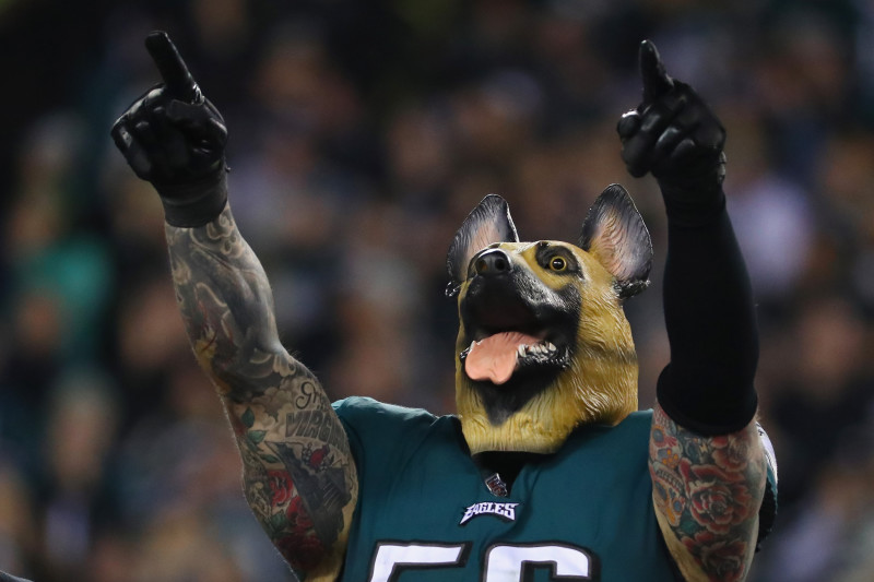 Philadelphia Eagles defensive end Chris Long (56) celebrates as he wears a  dog mask after the