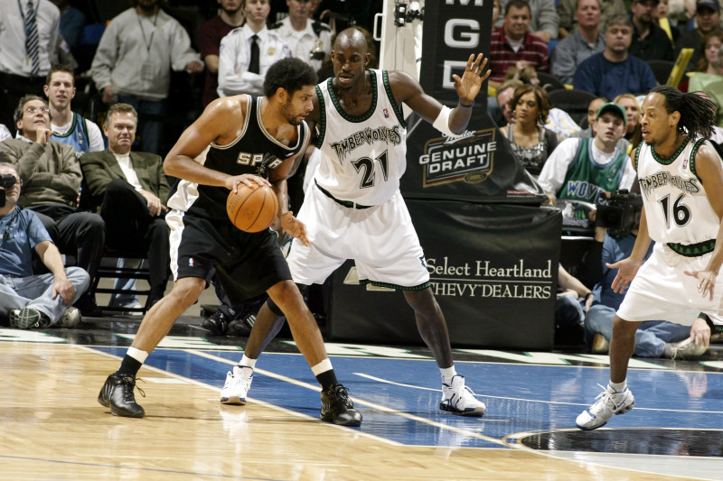 MINNEAPOLIS - DECEMBER 15:  Tim Duncan #21 of the San Antonio Spurs looks to make a move around Kevin Garnett #21 of the Minnesota Timberwolves on December 15, 2005 at the Target Center in Minneapolis, Minnesota.  NOTE TO USER: User expressly acknowledges