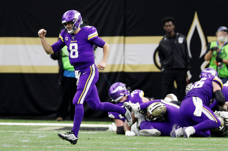 Minnesota Vikings quarterback Kirk Cousins (8) looks to hand off the ball  during an NFL match between Minnesota Vikings and New Orleans Saints at the  Tottenham Hotspur stadium in London, Sunday, Oct.