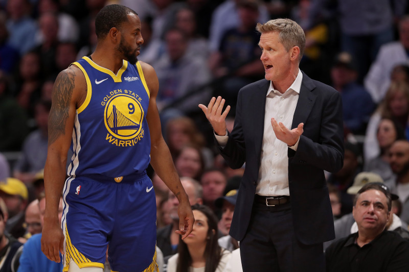 DENVER, COLORADO - JANUARY 15: Andre Iguodala #9 of the Golden State Warriors confers with head coach Steve Kerr while playing the Denver Nuggets at the Pepsi Center on January 15, 2019 in Denver, Colorado. NOTE TO USER: User expressly acknowledges and ag