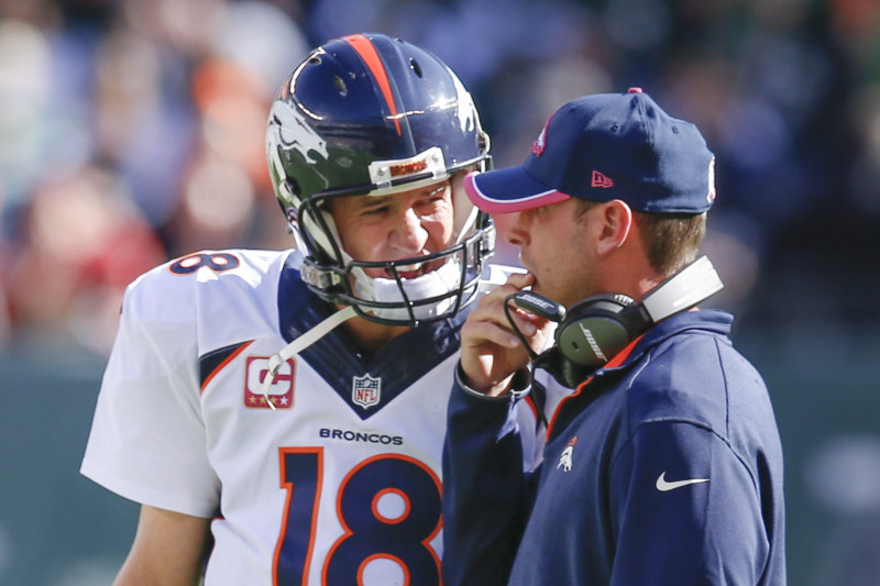 Denver Broncos quarterback Peyton Manning listens to his coach