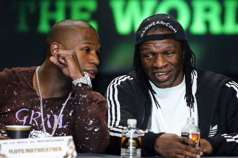 LAS VEGAS - FEBRUARY 27:  Boxer Floyd Mayweather Jr. (L) talks to his father and trainer Floyd Mayweather Sr. during a news conference at the MGM Grand Hotel/Casino as part of a media tour announcing his fight with Oscar De La Hoya February 27, 2007 in Las Vegas, Nevada. De La Hoya and Mayweather will fight for the junior middleweight championship May 5, 2007, at the MGM.  (Photo by Ethan Miller/Getty Images)