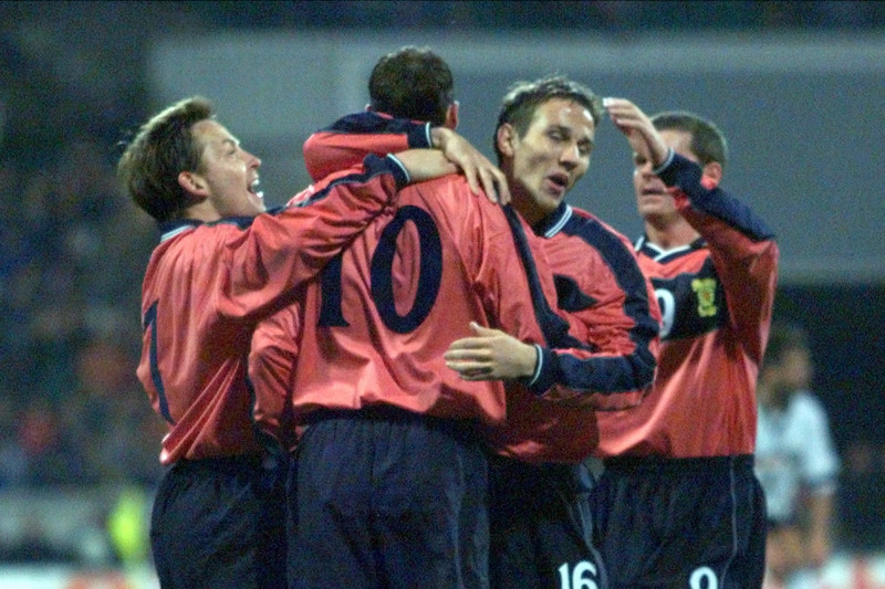 Scotish Don Hutchison, No.10, is congratulated by teammates Billy Dodds, left, Ian Durrant, right, and Eoin Jess after scoring a goal during the friendly soccer match Germany versus Scotland at the Bremen Weser stadium, northern Germany, Wednesday, April 28, 1999. (AP Photo/Michael Probst)
