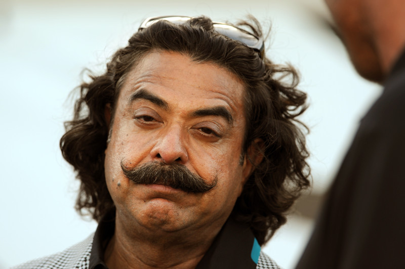 Jacksonville Jaguars owner Shad Khan, left, shakes hands with Tony Boselli, right, before an NFL preseason football game against the Miami Dolphins, Friday, Aug. 9, 2013, in Jacksonville, Fla. (AP Photo/Stephen Morton)