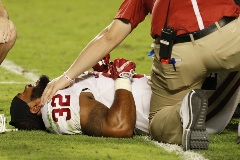 Oklahoma running back Samaje Perine (32) is attended on the field after he was injured on a play, during the second half of the Orange Bowl NCAA college football semifinal playoff game against Clemson, Thursday, Dec. 31, 2015, in Miami Gardens, Fla. (AP Photo/Joe Skipper)