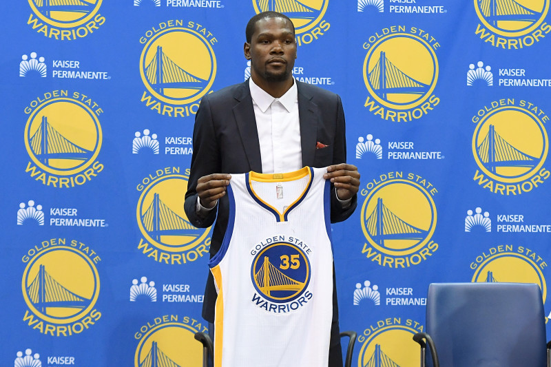 OAKLAND, CA - JULY 07:  Kevin Durant #35 of the Golden State Warriors poses with his new jersey during the press conference where he was introduced as a member of the Golden State Warriors after they signed him as a free agent on July 7, 2016 in Oakland, California.  (Photo by Thearon W. Henderson/Getty Images)