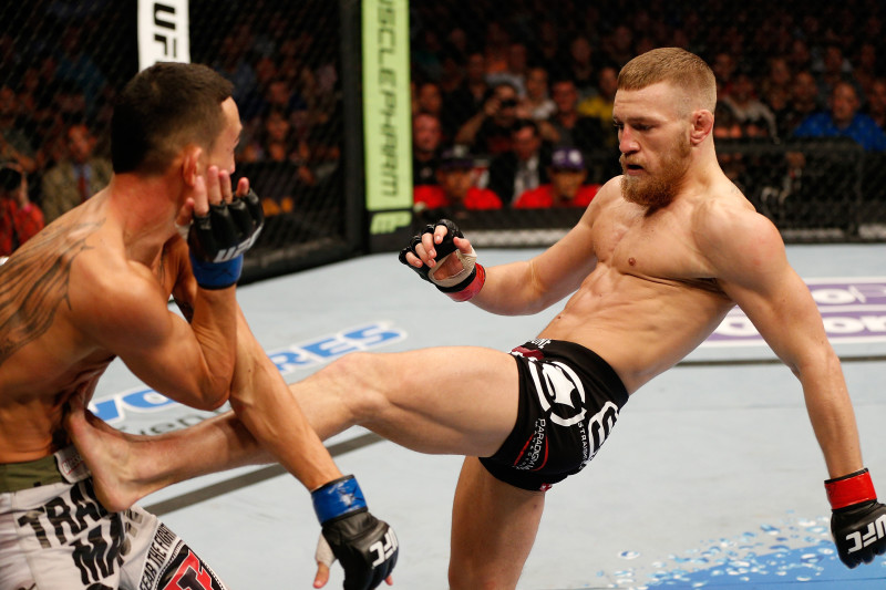 BOSTON, MA - AUGUST 17:  (R-L) Conor McGregor kicks Max Holloway in their UFC featherweight bout at TD Garden on August 17, 2013 in Boston, Massachusetts. (Photo by Josh Hedges/Zuffa LLC/Zuffa LLC via Getty Images)