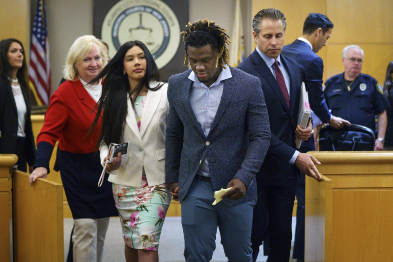 ADDS THE IDENTIFICATION OF THE PERSON AT LEFT - Philadelphia Phillies baseball player Odubel Herrera leaves a courtroom with his girlfriend, Melany Martinez-Angulo, after a hearing on a domestic violence case in Atlantic City, N.J., Wednesday, July 3, 2019. Domestic assault charges against Herrera were dismissed Wednesday after his girlfriend declined to press charges. (Jessica Griffin/The Philadelphia Inquirer via AP, Pool)